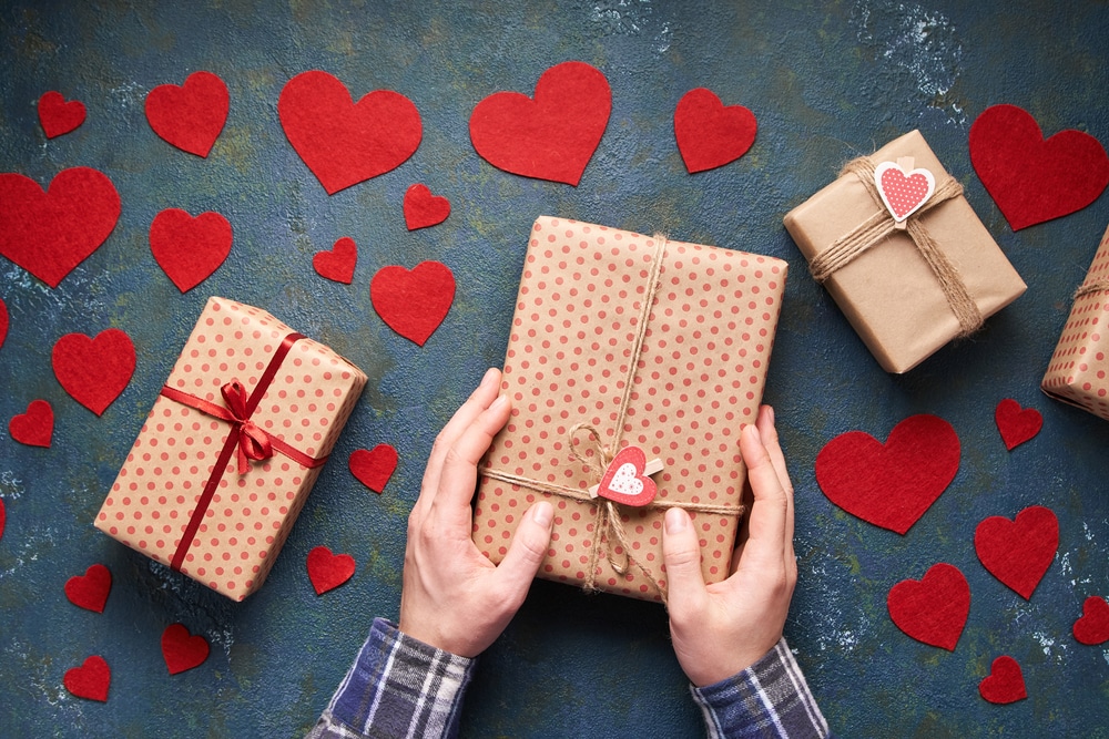 Man wrapping valentines gifts
