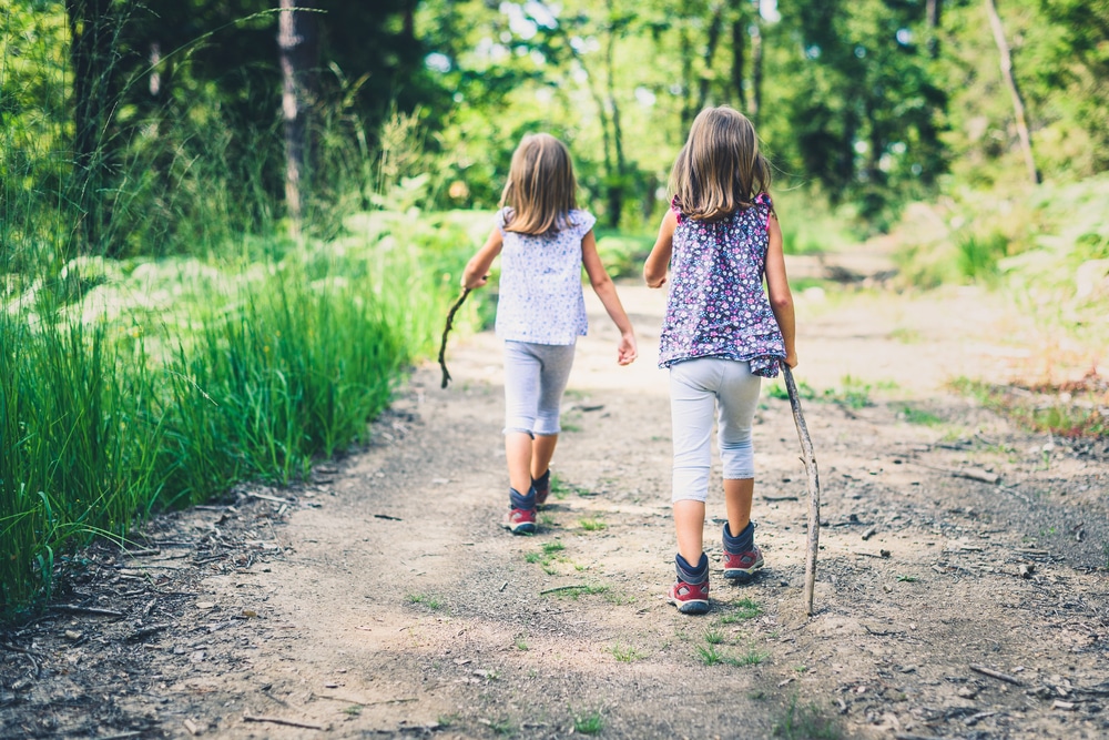 Little girls walking in the woods