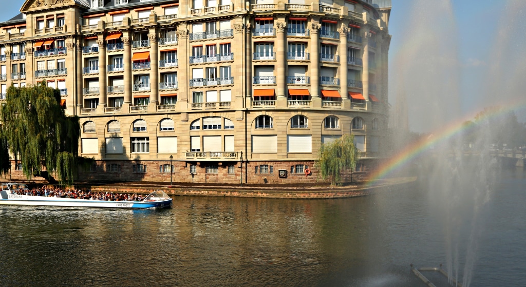 Boat on canal with rainbow