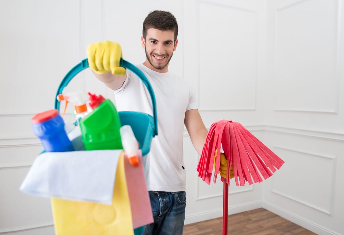 Man holding cleaning supploes