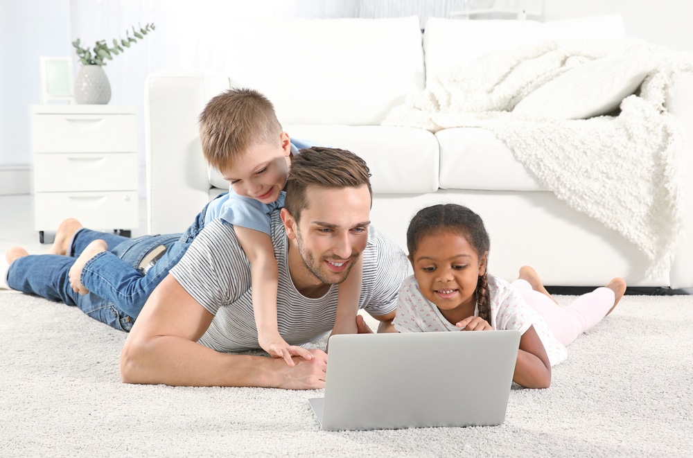Foster father with children using laptop