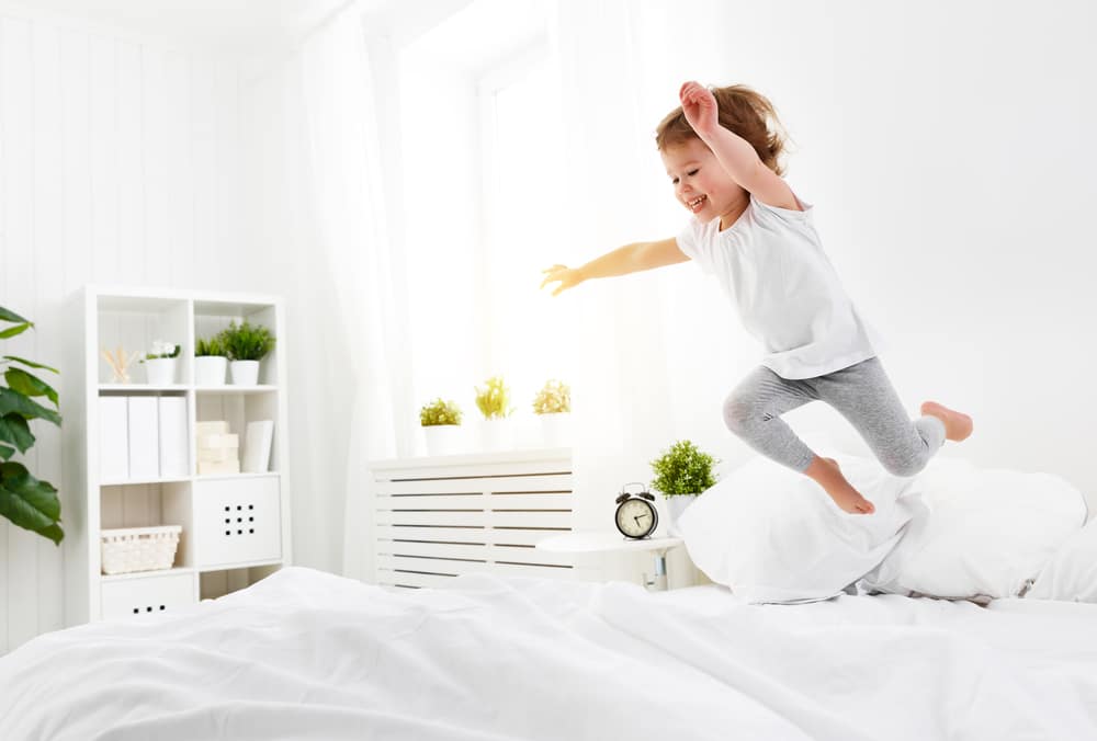 Child jumping on bed