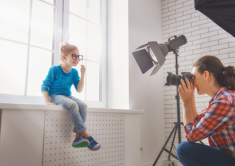 Female photographer photographing little boy