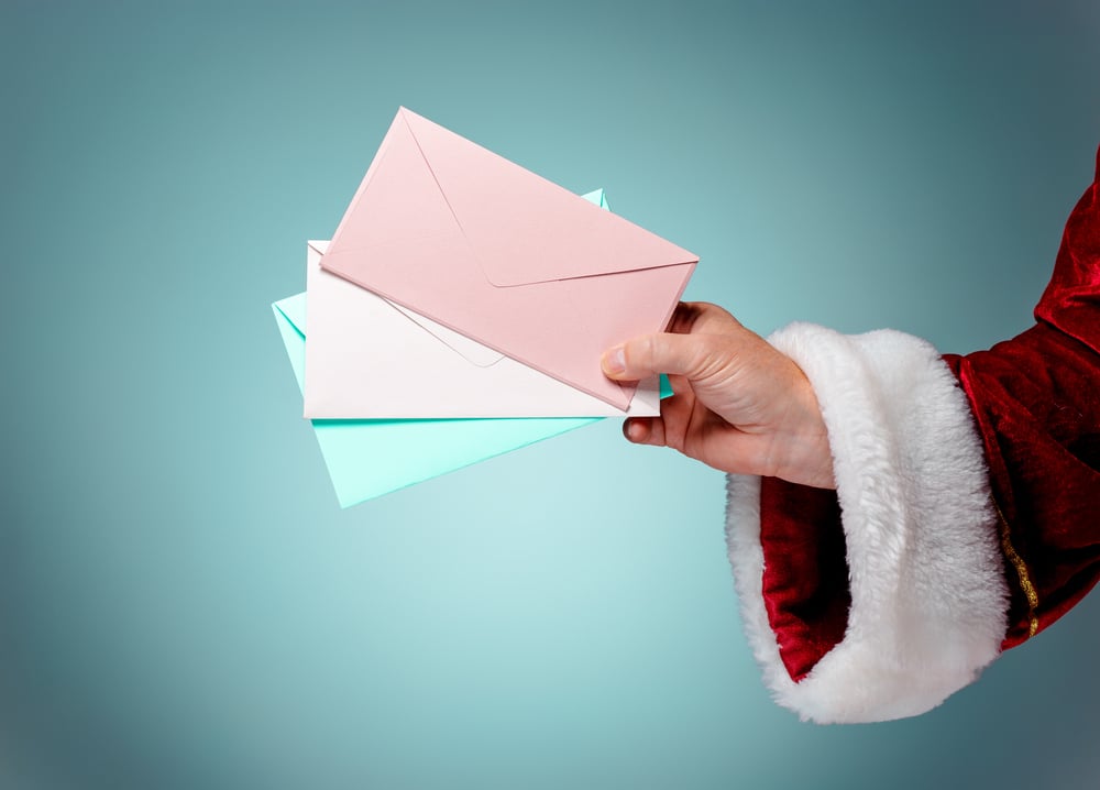 Santa's hand holding letters