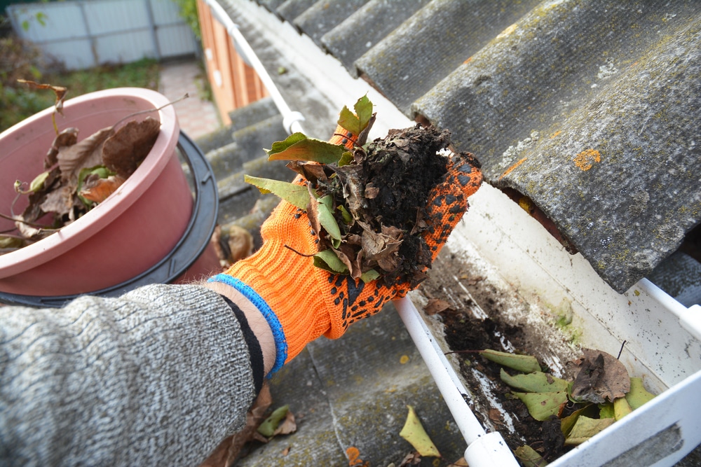 Clearing dirt and leaves from a gutter