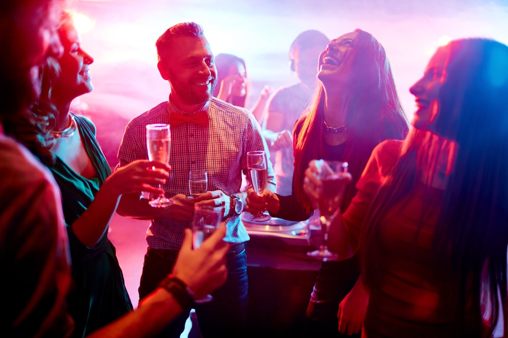 Group laughing and drinking in nightclub