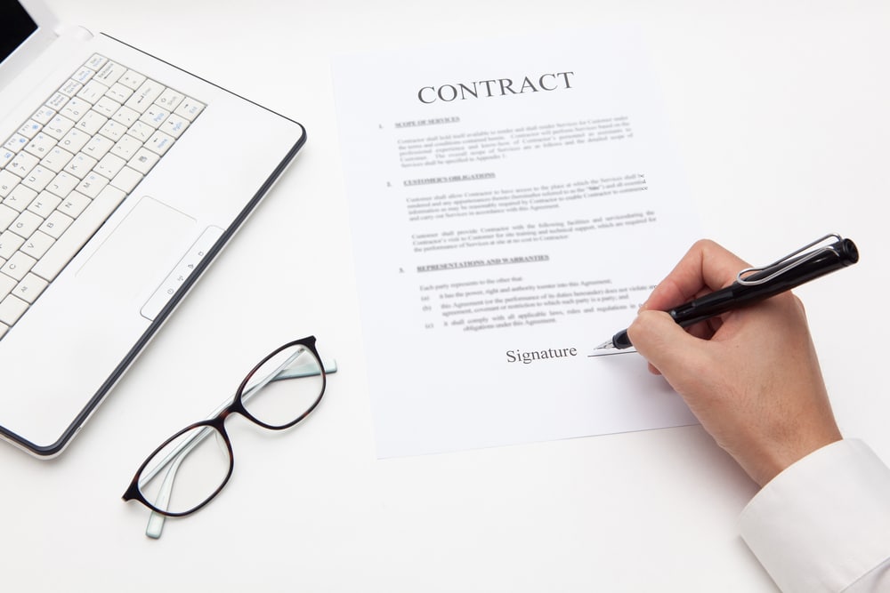 Someone signing a contract