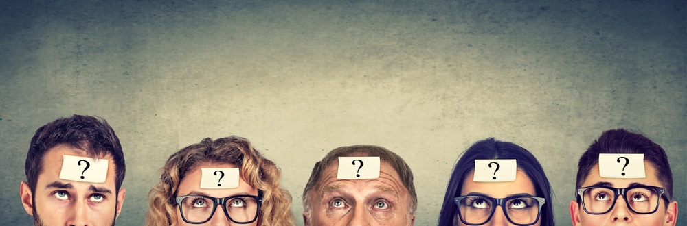 Group of people looking up at question marks on their foreheads