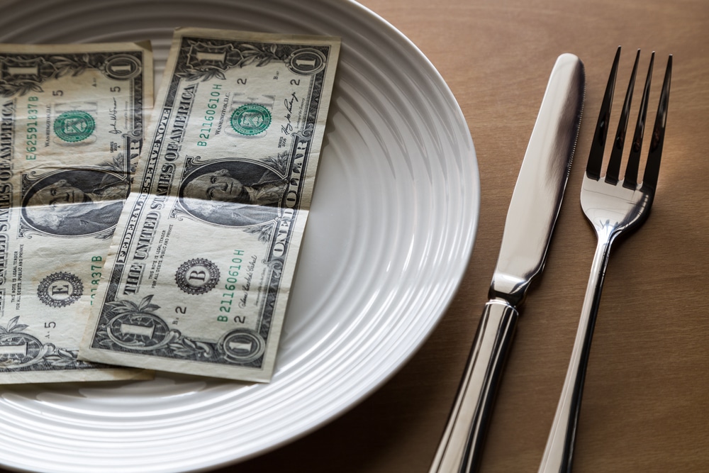 Dollar bills on dinner plate