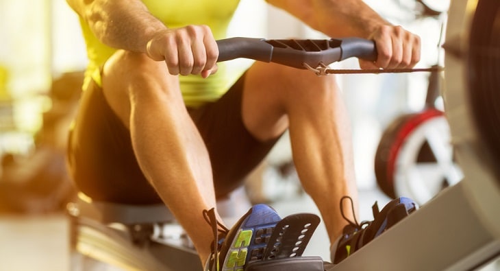 Man using a rowing machine in a gym