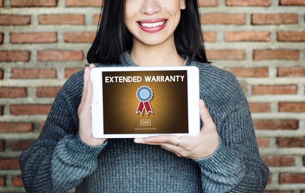 Woman holding tablet that says Extended Warranty on
