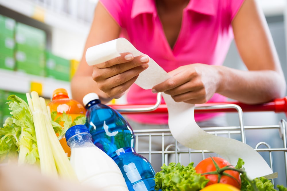 Woman looking at grocery bill