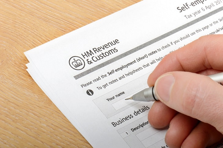 Person filling in HMRC tax forms