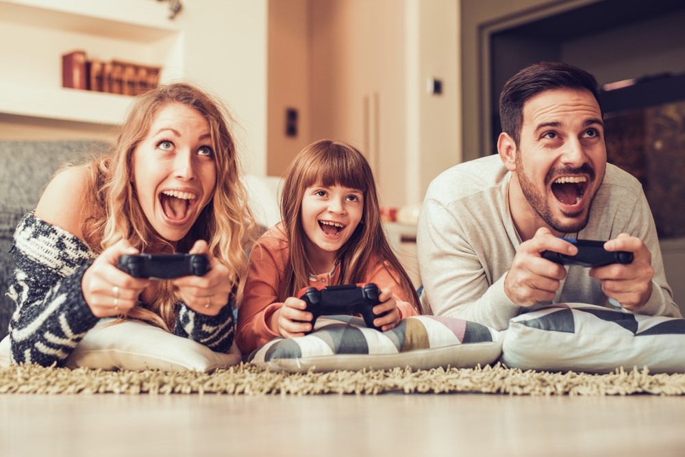 Happy family playing video games together