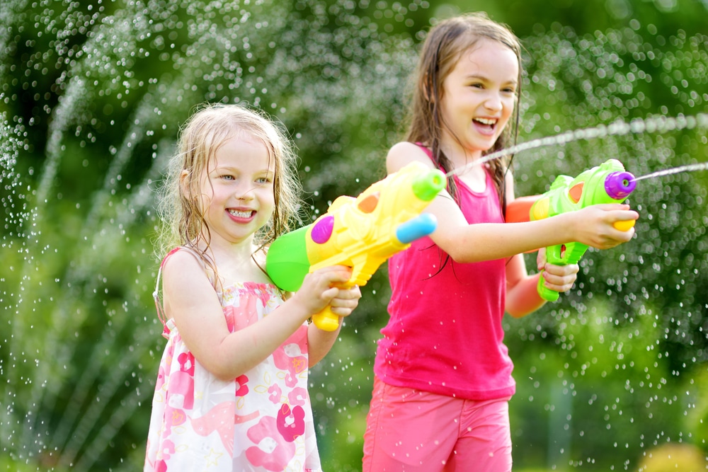 Little girls with water guns