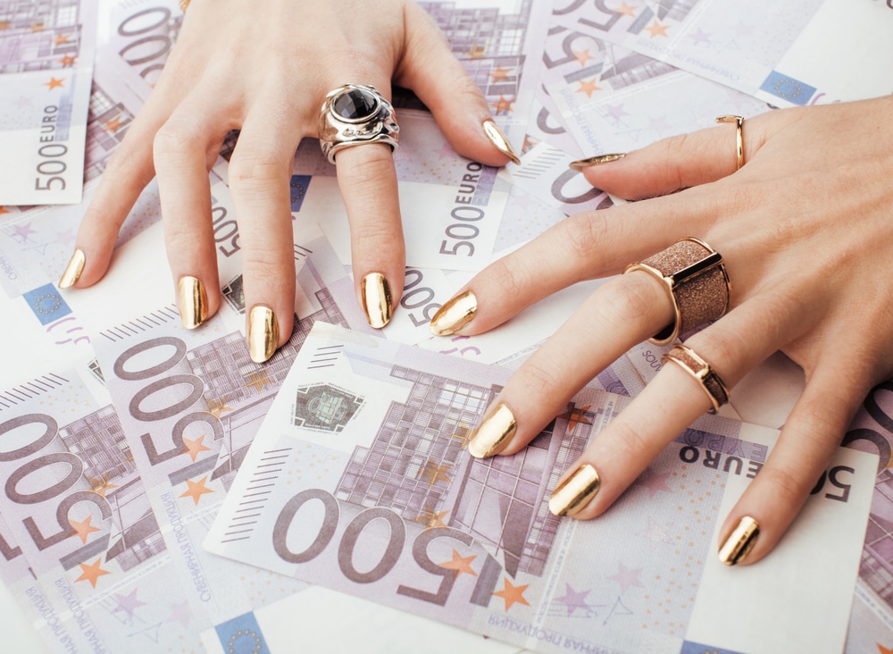 Manicured hands on top of money