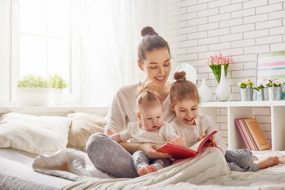 Young female babysitter reading story