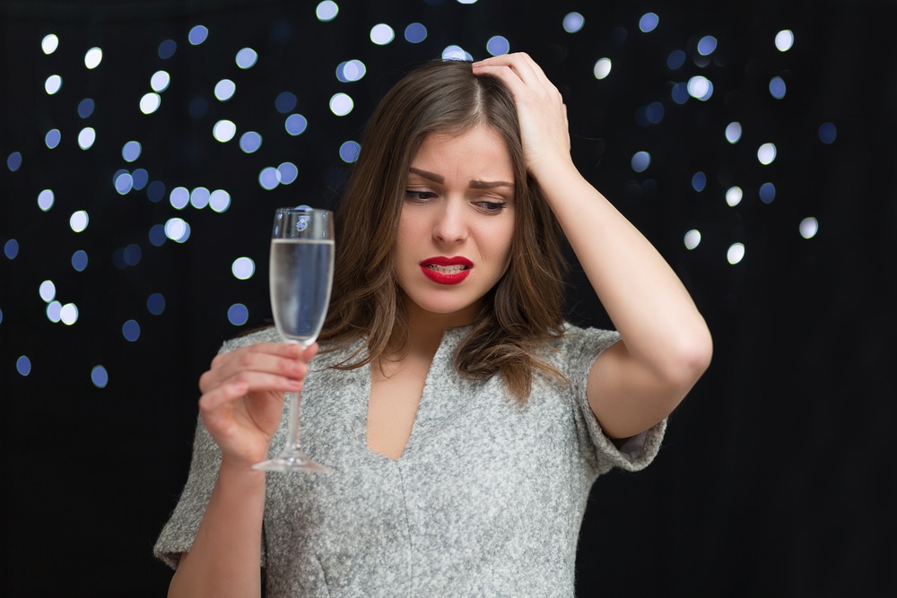 Woman with headache after drinking too much