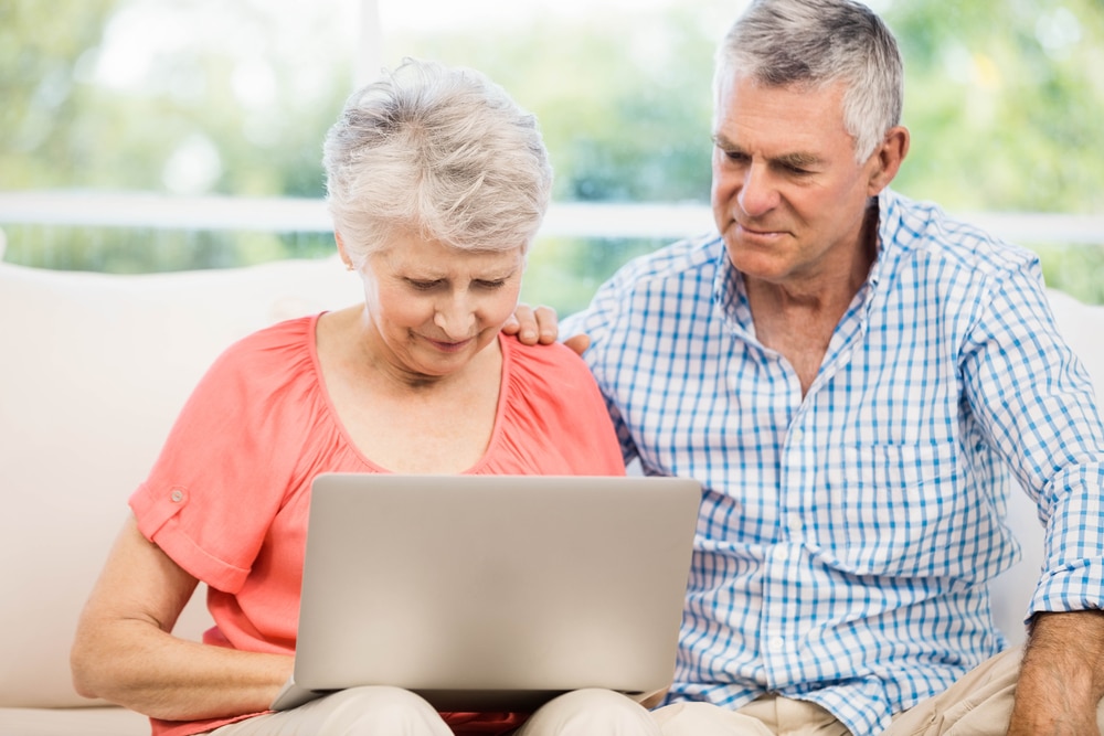 Senior couple using laptop