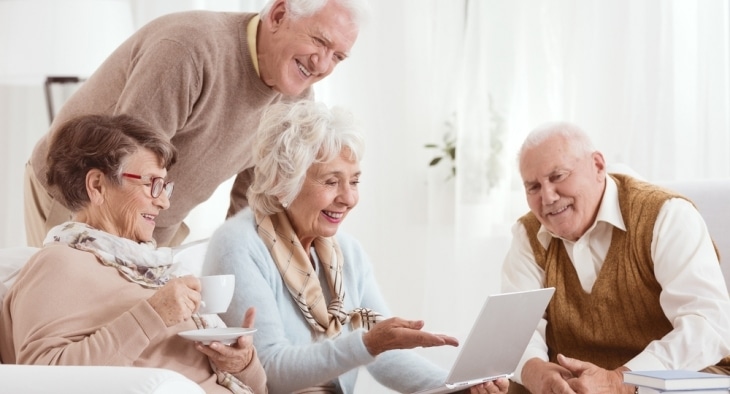 Group of pensioners looking at a laptop