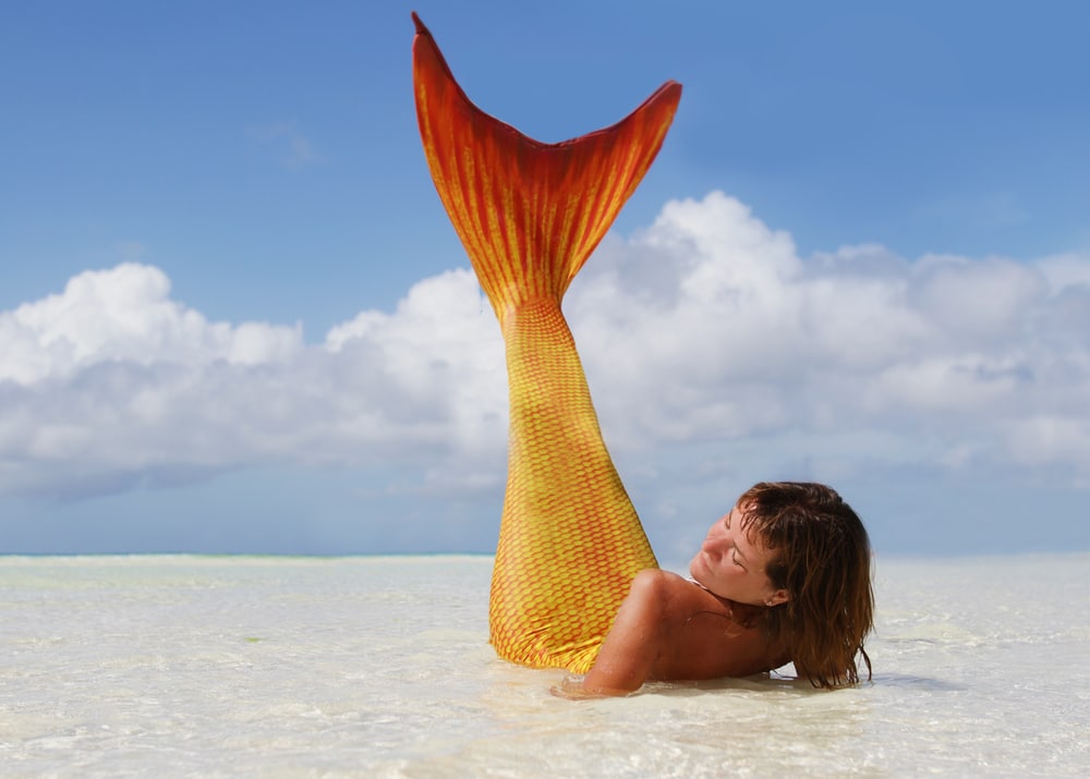 Mermaid lying on a beach