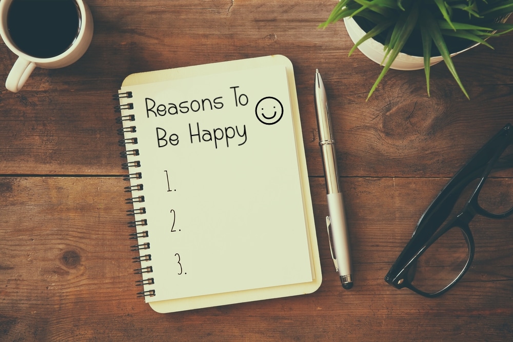 Reasons to be happy list in notebook