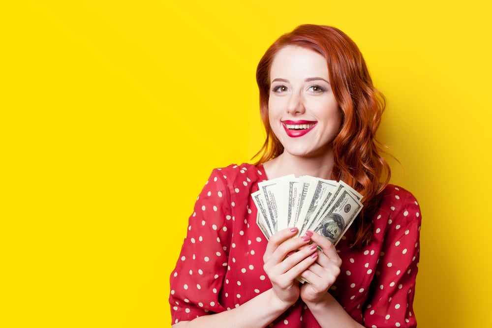 Smiling woman holding cash