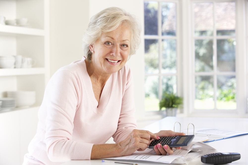 Senior woman calculating her finances