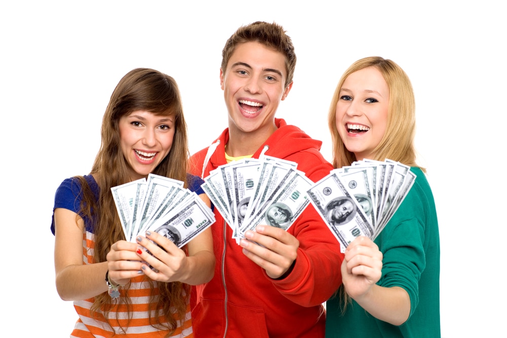 Teens holding cash