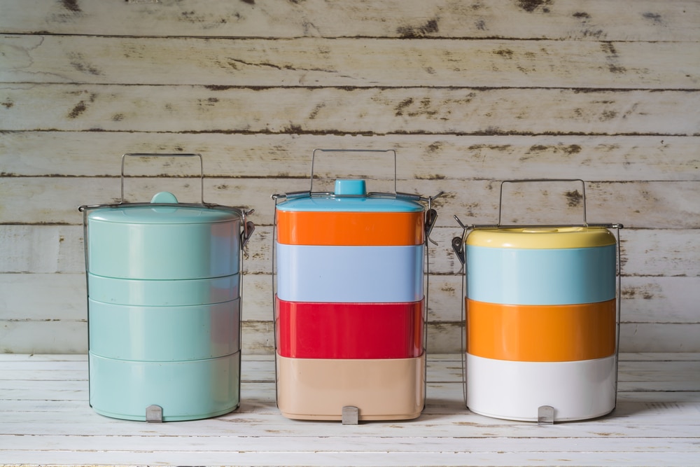 Three brightly coloured tiffin lunch boxes