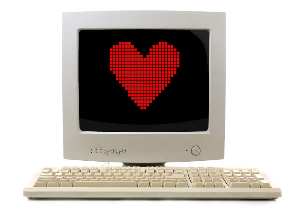 Old computer with pixel heart on the screen