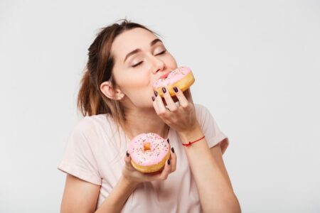 Woman eating doughnuts