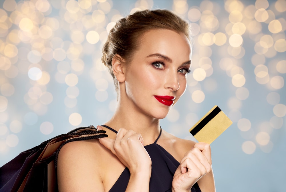 Woman holding gold credit card