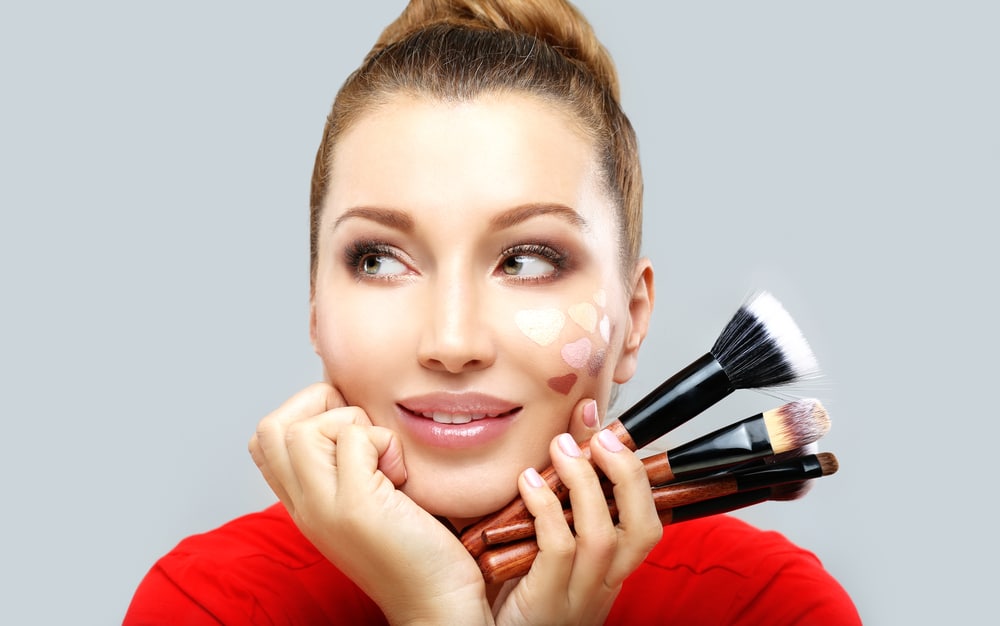 Woman holding makeup brushes
