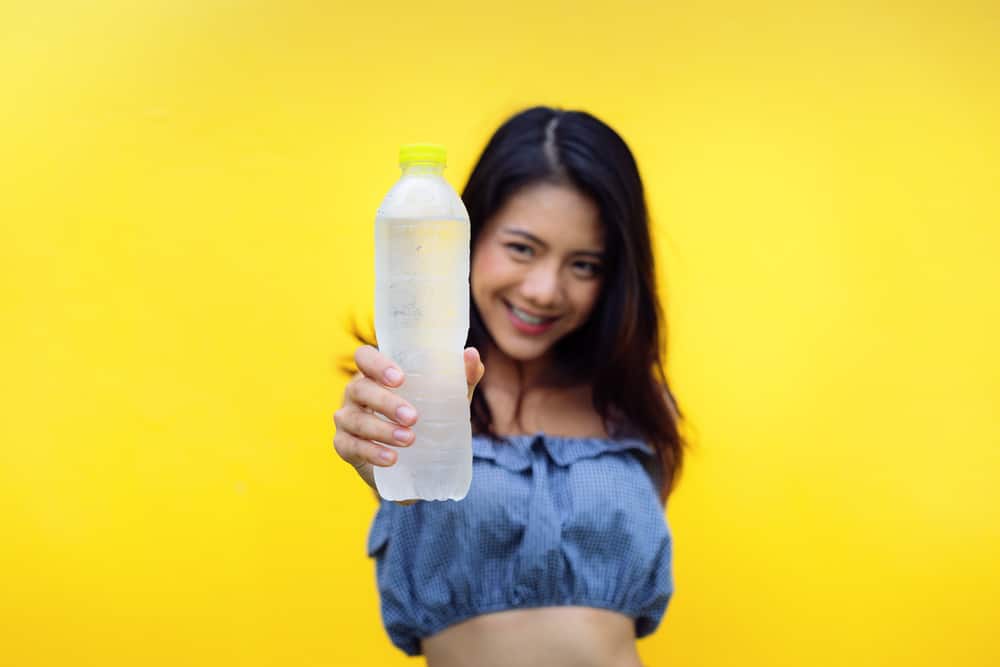 woman holding water bottle