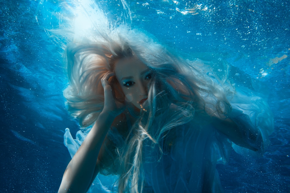 Blonde mermaid underwater