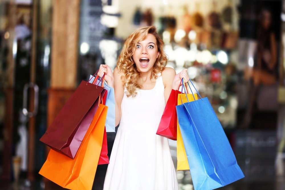 Excited woman with shopping bags