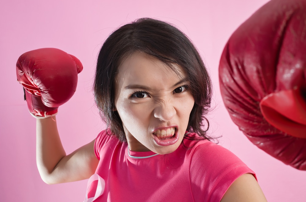 Woman looking aggressive in boxing gloves