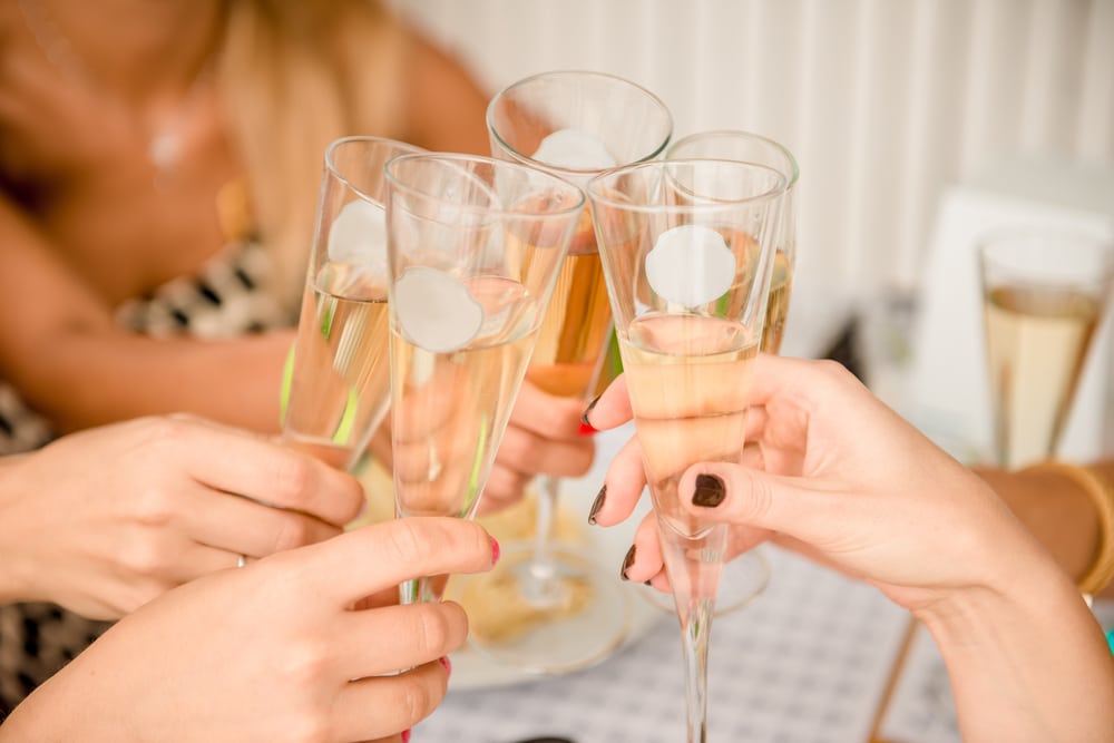 Women cheersing champagne glasses