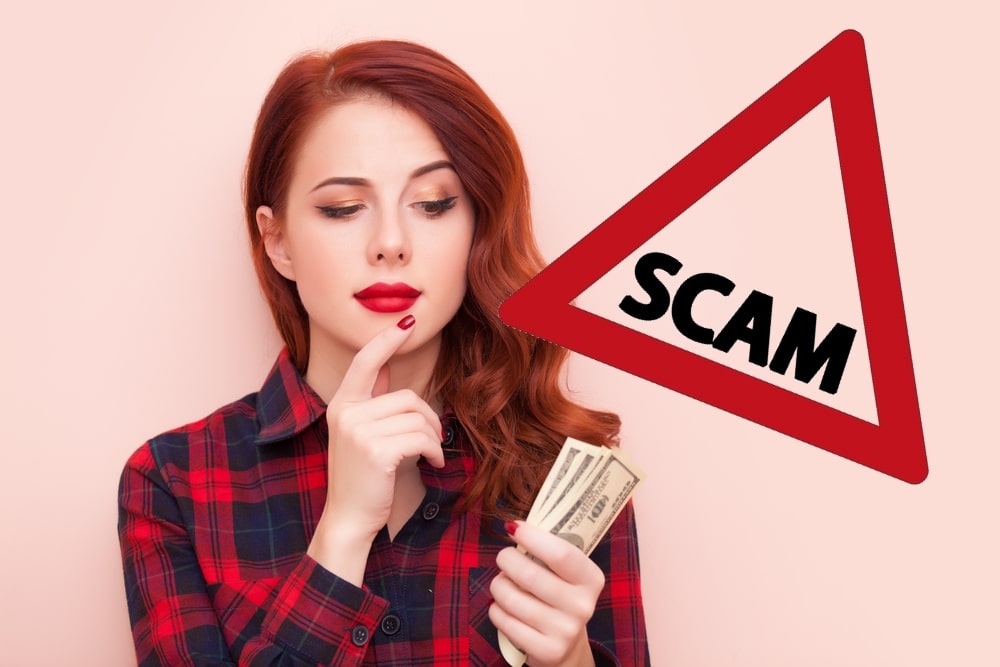 Woman looking at money in her hand quizzically and a scam warning sign laid over the top