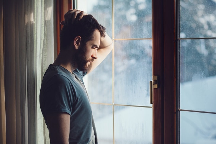 anxious man looking out of the window