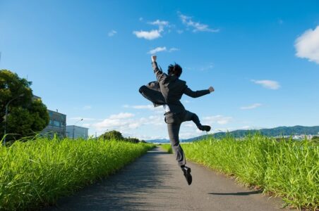 happy dividend income investment trusts investors jumping on a road