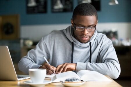 Man writing notes and preparing investments for a recession