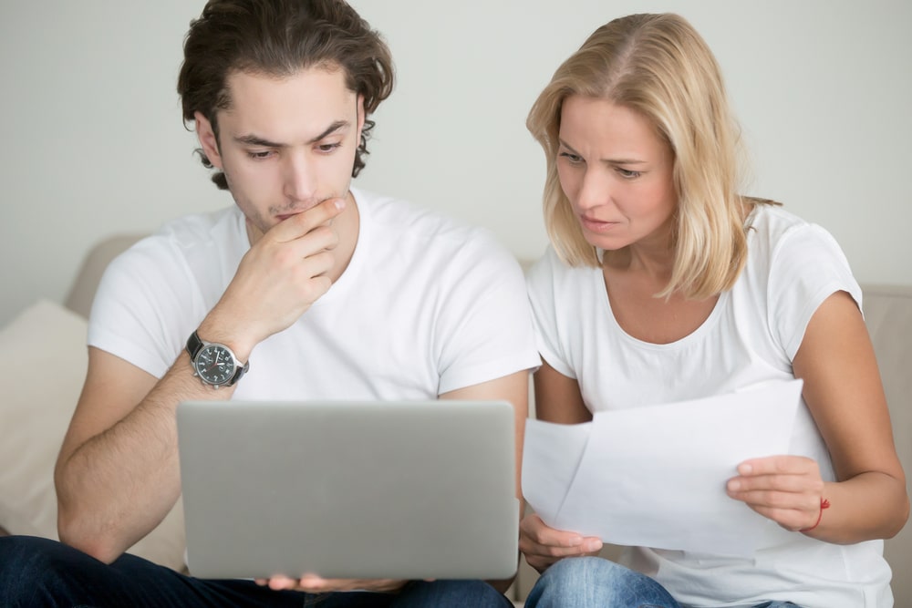 Couple choosing a type of cover on a laptop