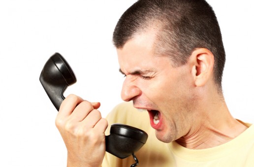 Man shouting at annoying cold caller on phone