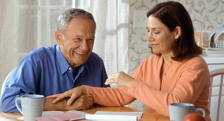 Woman and older man laughing together