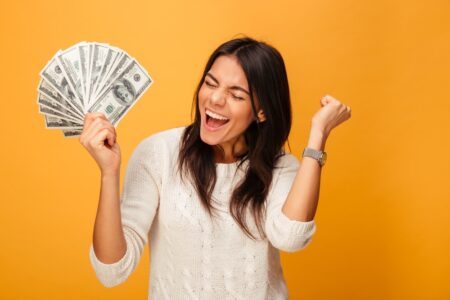 woman happy holding investment trust income in hand