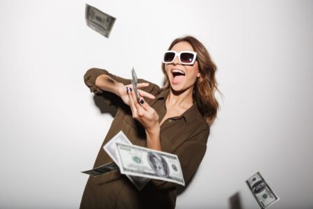 woman happy and throwing dividend dollars