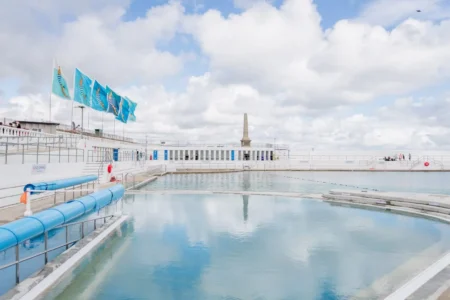 Jubilee Pool in Penzance, Cornwall, overlooking the sea on a sunny day.